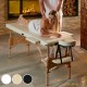 Table de massage pliable en bois beige avec réglage de hauteur et accoudoirs.