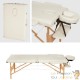 Table de massage pliable en bois beige avec réglage de hauteur et accoudoirs.